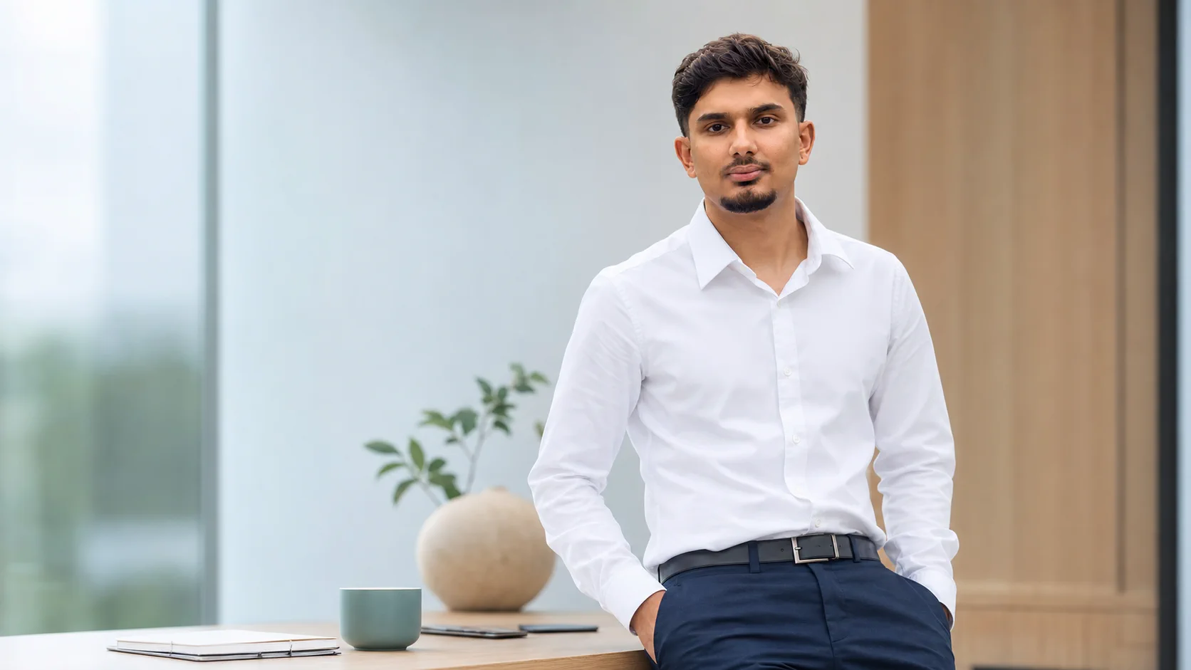 Ananta Sharma in a professional consulting office representing practical AI automation for small business